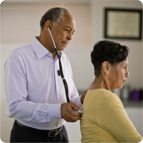 General practitioner checking woman's heart rate