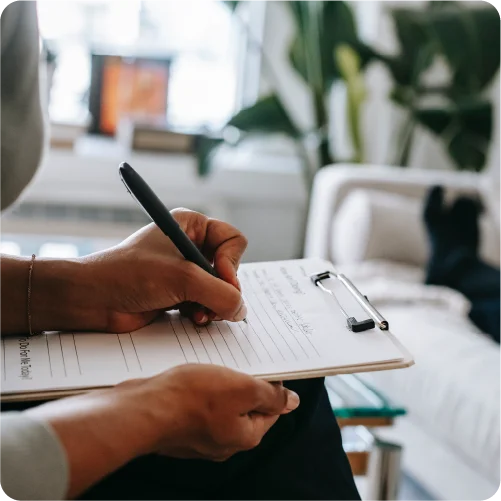 Doctor writing notes on a clip board